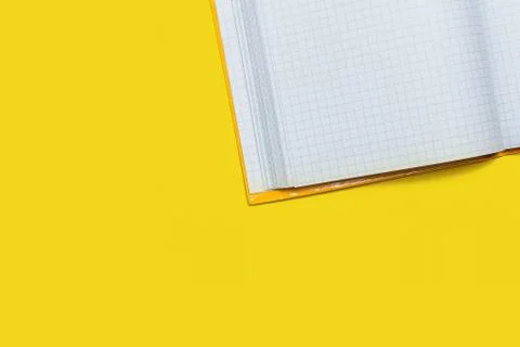 Opened workbook on a yellow background Stock Photos