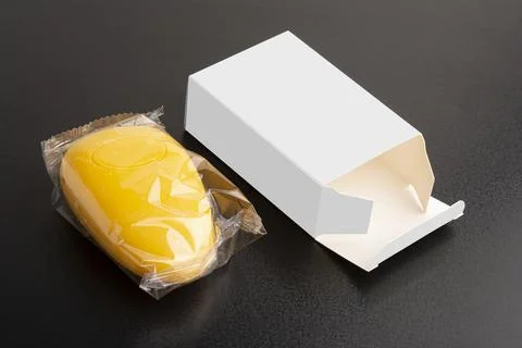 Opened yellow soap package on black surface mock-up series Stock Photos
