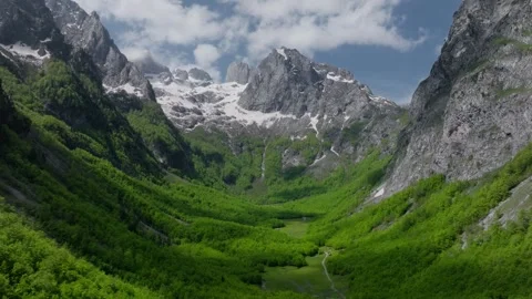 Opening aerial view fly through forest and clouds to mountain valley Stock Footage 250000029
