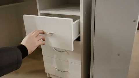 Opening and closing the drawers in the table Stock Footage 86159959