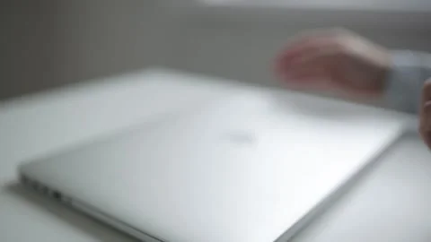Opening and closing the laptop for work. Office situation before work. Stock Footage 105724839