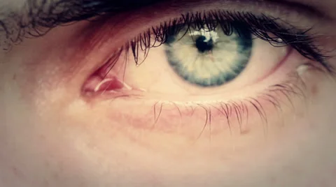Opening and closing of one eye of young man very sad - tears Stock Footage