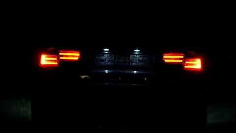 Opening and closing the trunk of the car at night Stock Footage 136858851