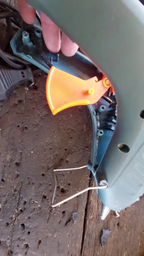 Opening and disassembling a plastic hot glue gun shell Stock Footage 334679037