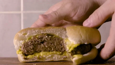 Opening and presenting a burger Stock Footage 132036819