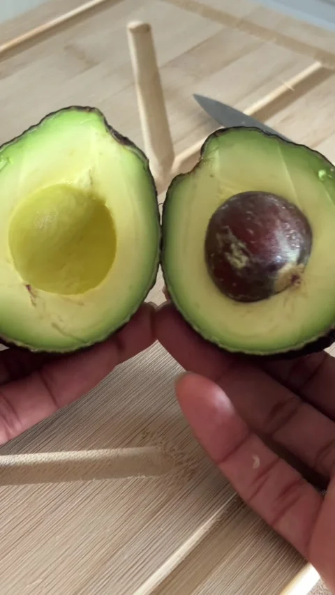 Opening an avocado Stock Footage 312717822
