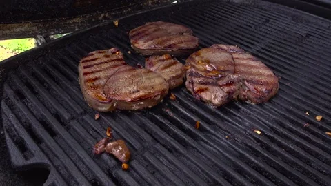 Opening BBQ Lid to Reveal Beef Steaks Cooking on the Grill 库存影片 345008049