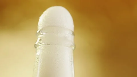 Opening beer bottle, foam texture close-up. Glass bottle with alcohol drink on Stock Footage 198737002