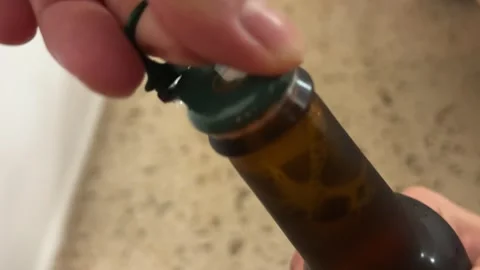 Opening the beer bottle with hands Stock Footage 245489936