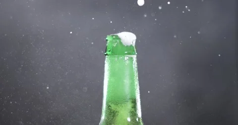 Opening a beer bottle with a spray of foam in super slow motion Stock Footage 339303723