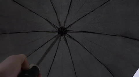 Opening the black automatic umbrella on cloud background when rain approaching Stock Footage 64702350