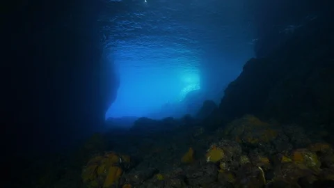 Opening onto the blue sea seen from below and from in, Ustica, Mediterranean sea Stock Footage 125996904