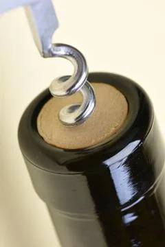 Opening bottle with corkscrew Stock Photos