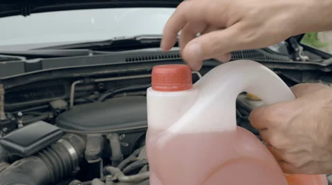 Opening bottle with pink windshield washer fluid Stock Footage 63624573