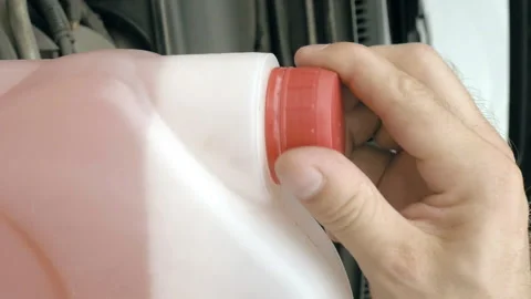 Opening bottle with pink windshield washer fluid Stock Footage 91179187