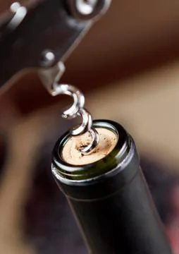 Opening of bottle of wine with corkscrew Stock Photos