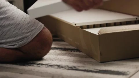 Opening Box and Taking Out Furniture Parts on Floor Video stock 344145985