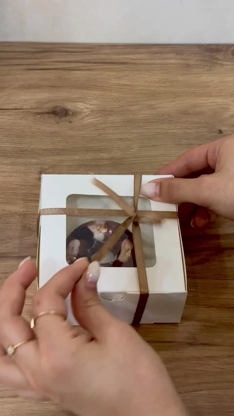 Opening box of donut on wooden table, vertical view Stock Footage 345159563