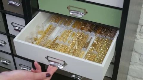 Opening box with various bottles of beads Stock Footage 73497829