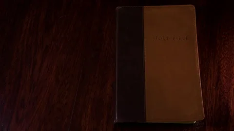 Opening up a brown leather bound bible to the New Testament. Stock Footage