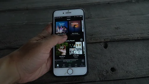 Opening, browsing and scrolling Spotify application. Stock Footage 88379982