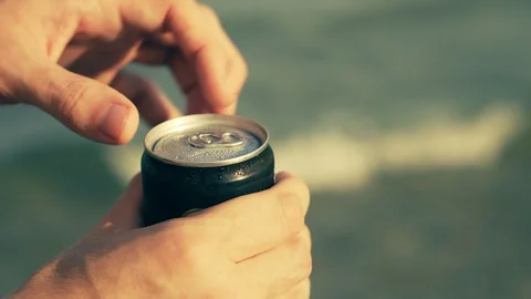 Opening a Can of Beer on Beach Stock Footage 129282324