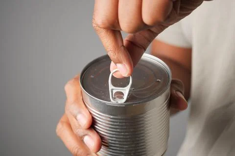 Opening a can with a pull tab for easy access Stock Photos