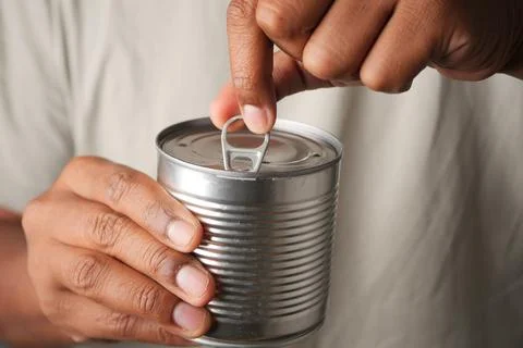 Opening a can with a pull tab at home Stock Photos