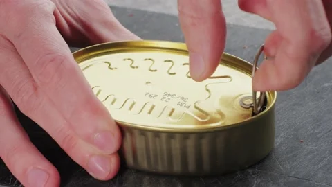 Opening canned octopus squid fish can, man open the canned seafood on the table Stock Footage 237951328