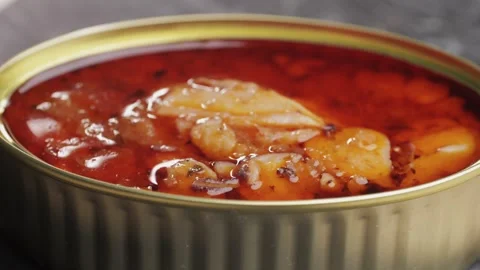 Opening canned octopus squid fish can, man open the canned seafood on the table Stock Footage 279837423