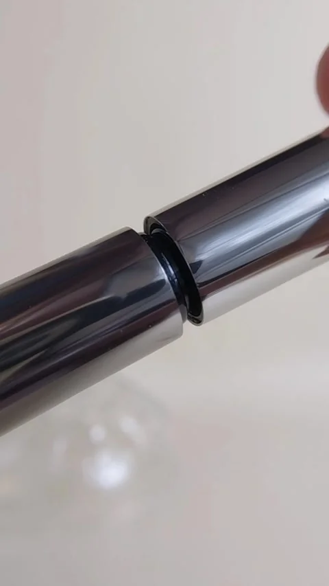 Opening the cap of silver mascara packaging. Vertical close up of beauty pr.. Stock Footage 340077312