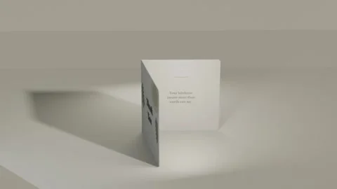 Opening card turning on table under spotlight, casting left shadow, revealing Stock Footage 339721857
