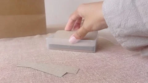 Opening a cardboard box on a brown table Stock Footage 146255720