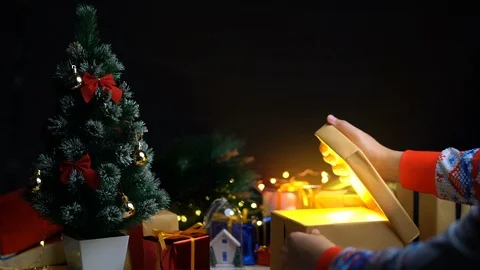 Opening Christmas Gift Glowing Light Come Out From The Box. Stock Footage 96340144
