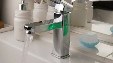 Opening a chrome tap, a flow of water. Stock Footage 147013781