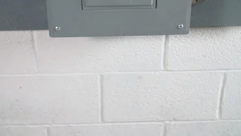 Opening Circuit Breaker Box on Basement Wall TILT UP Stock-Footage 104874891