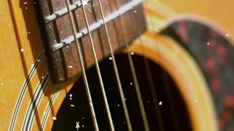 Opening close-up on guitar, star particles drifting and floating over strings Stock Footage 313329233