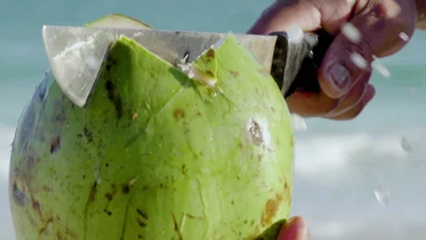 Opening coconut with machete in slow motion, close-up. Stock Footage 149829846