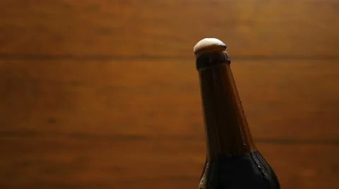 Opening cold bottle of beer with foam and spray Stockbeeldmateriaal 67295426