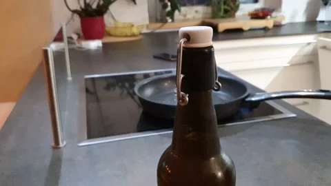 Opening cold bottle of beer with steam and spray (close-up) Stock Footage 158566642