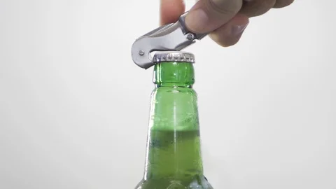 Opening cold green bottle beer with bottle opener background Closeup Slow Motion Stock-Footage 128326693