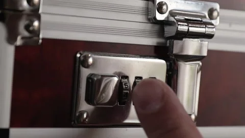 Opening the combination lock of metal suitcase close-up Stock Footage 131314383