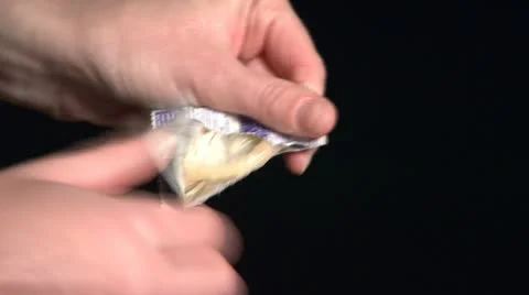 Opening a Condom Wrapper 3 Stock Footage 22333219