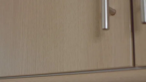 Opening cupboard and removing Tupperware Stock Footage 115254497
