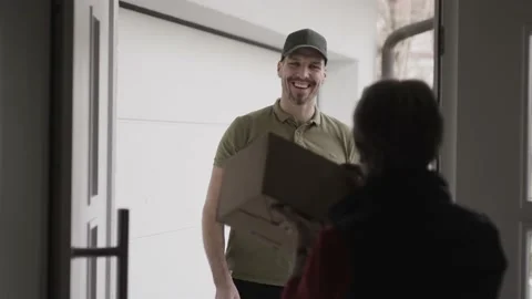 Opening the door for a courier delivering a package Stock Footage 149293877