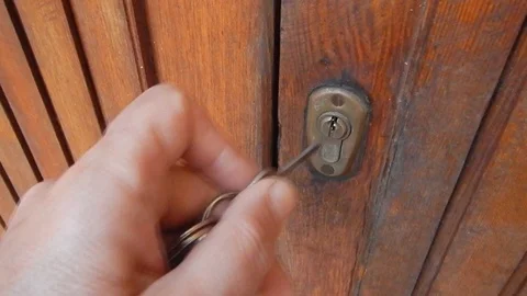 Opening the door using the key to operate the lock Stock Footage 105200886