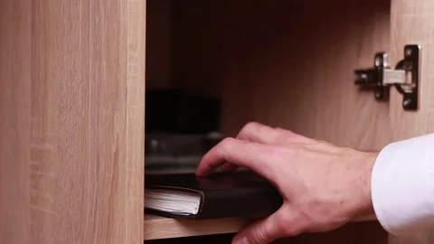 Opening drawer and taking notebook Stock Footage 85463145