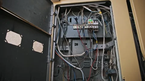 Opening an electrical box reveals wires: Junction box door and interior details Stock Footage 303865784