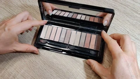 Opening eyeshadow palette mirror on the table Stock Footage 156666700