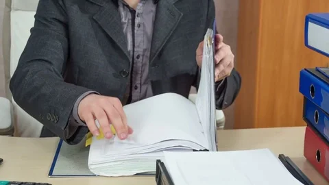 Opening the folder and searching for some documents Stock Footage 75442191